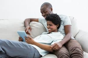 Hypnobabies Online Home Study Couple using tablet and relaxing on couch
