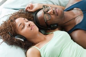 Hypnobabies Fertility Enhancement couple relaxing with headphones and eyes closed